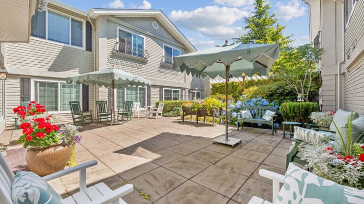 Outdoor patio area with seating and flowers