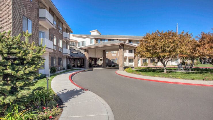 Exterior view of Cadence at Olney, featuring gardens and pathways