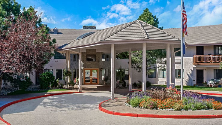 Exterior view of a nursing home entrance with gardens