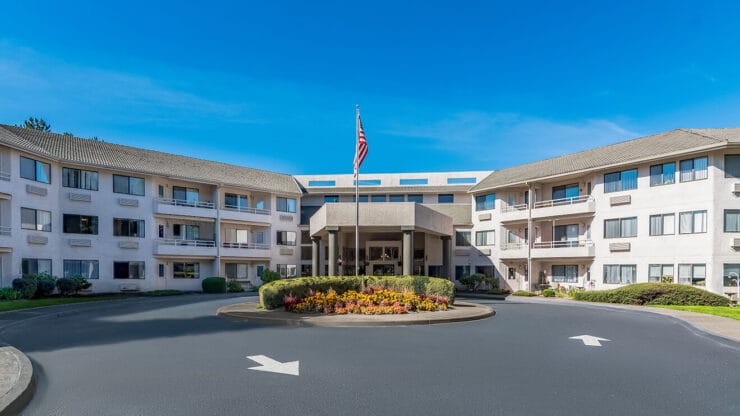 Exterior view of a senior living facility with a circular drive