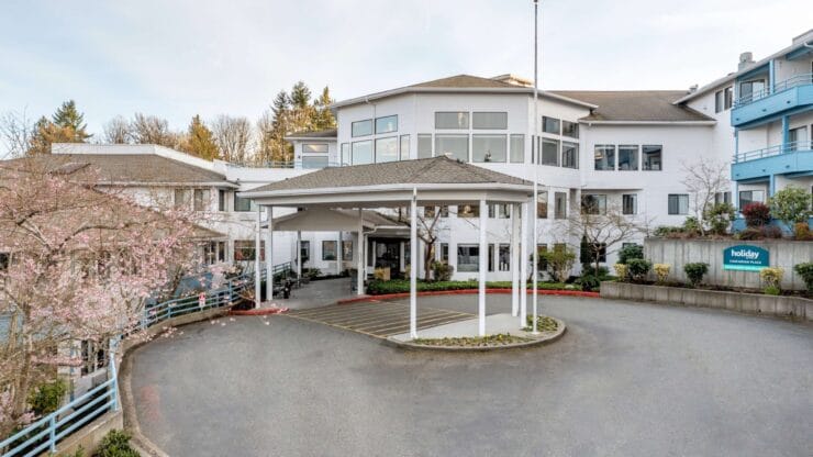 Exterior view of a senior living facility with landscaping