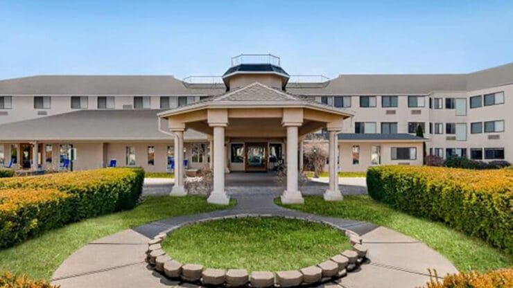 Exterior view of the facility with landscaped gardens