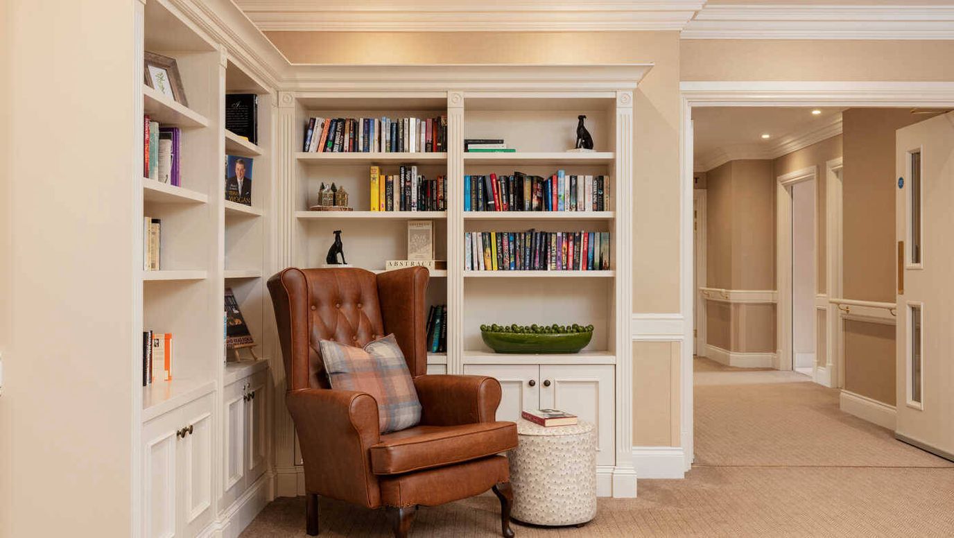 Cozy reading nook with bookshelves in a lounge