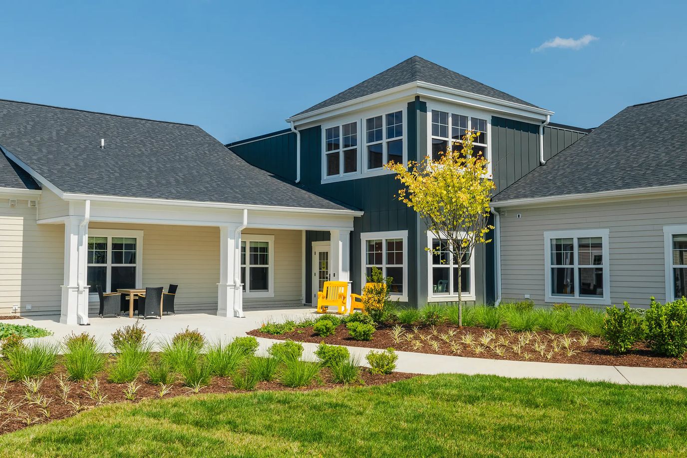 Exterior view of a senior living facility with garden