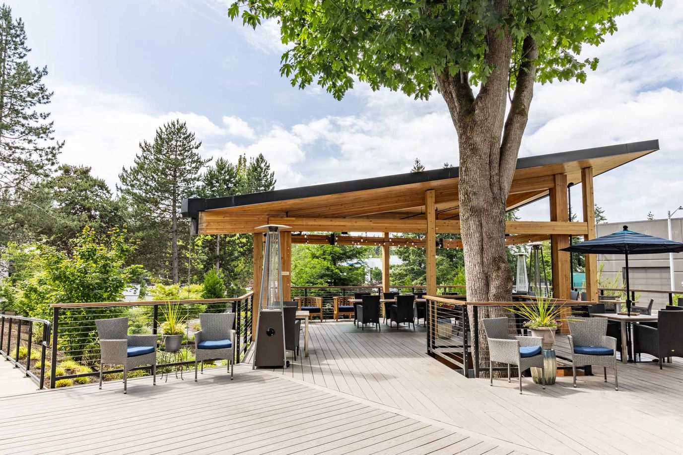 Outdoor dining area with seating and greenery