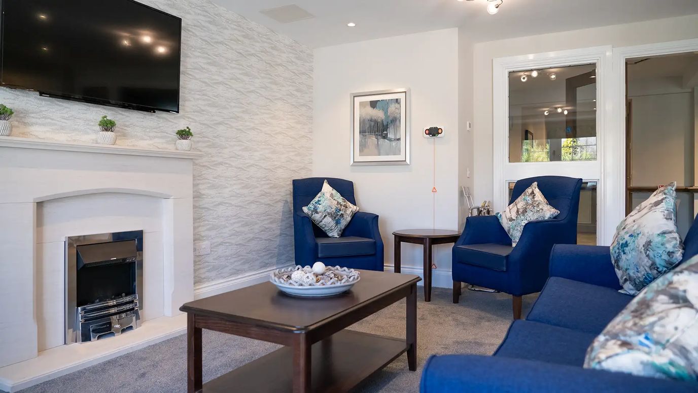 Cozy common area with blue seating and decor.