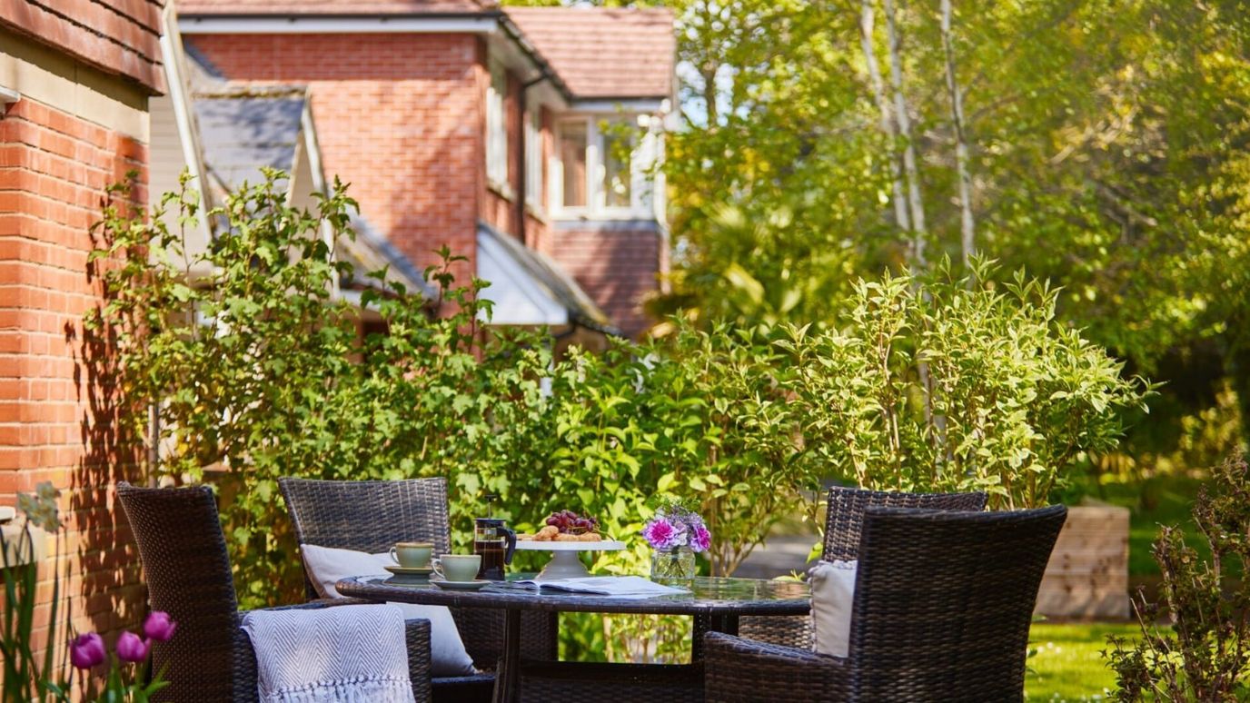 Outdoor seating area surrounded by greenery
