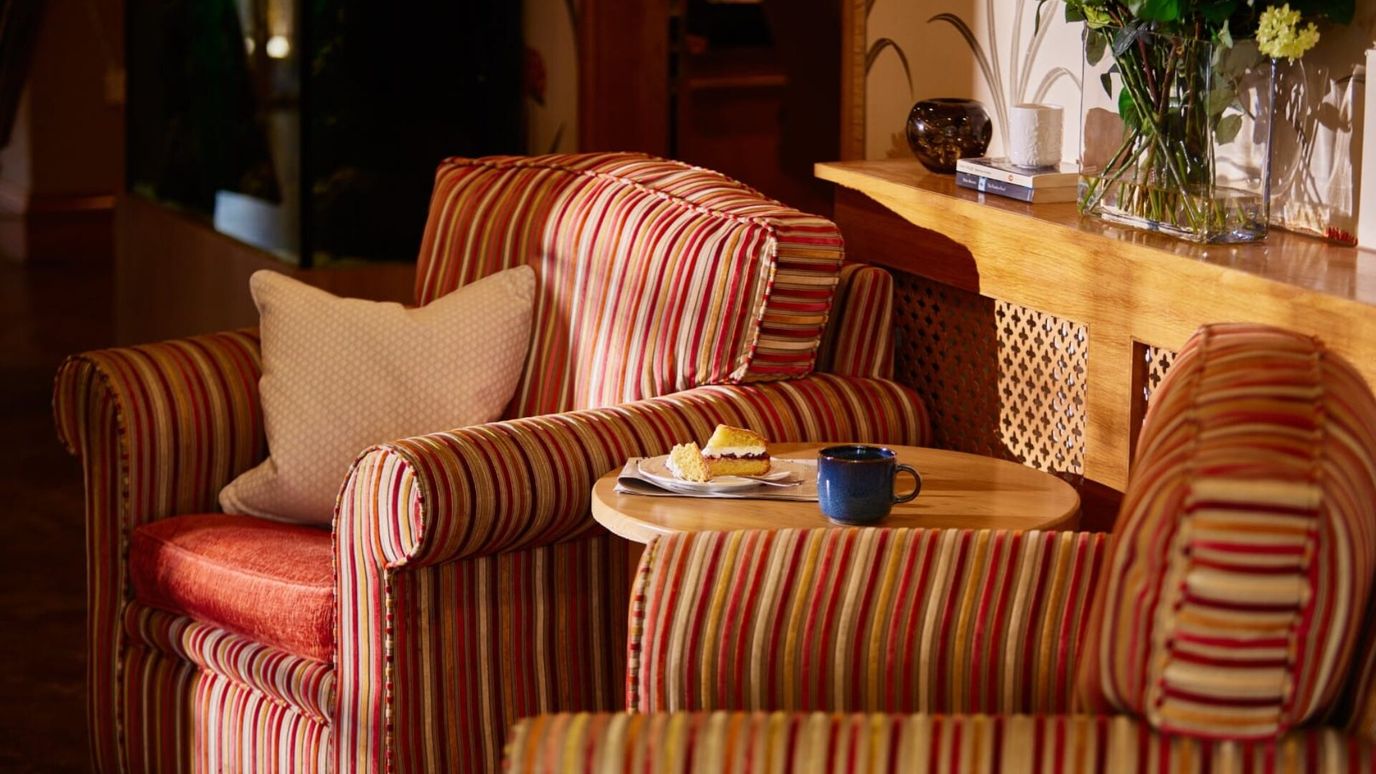 Cozy seating area with cake and coffee on a table