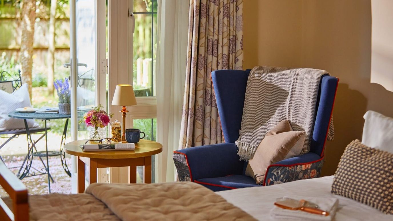 Cozy resident room with outdoor view and comfortable chair