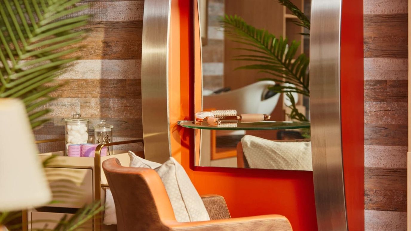 Interior of a salon area with a mirror and chair