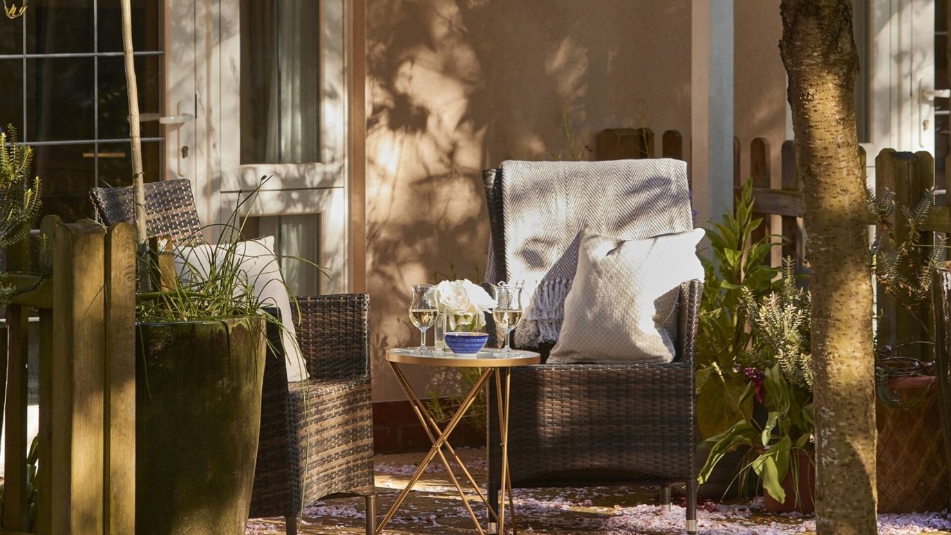 Outdoor seating area with plants and flowers