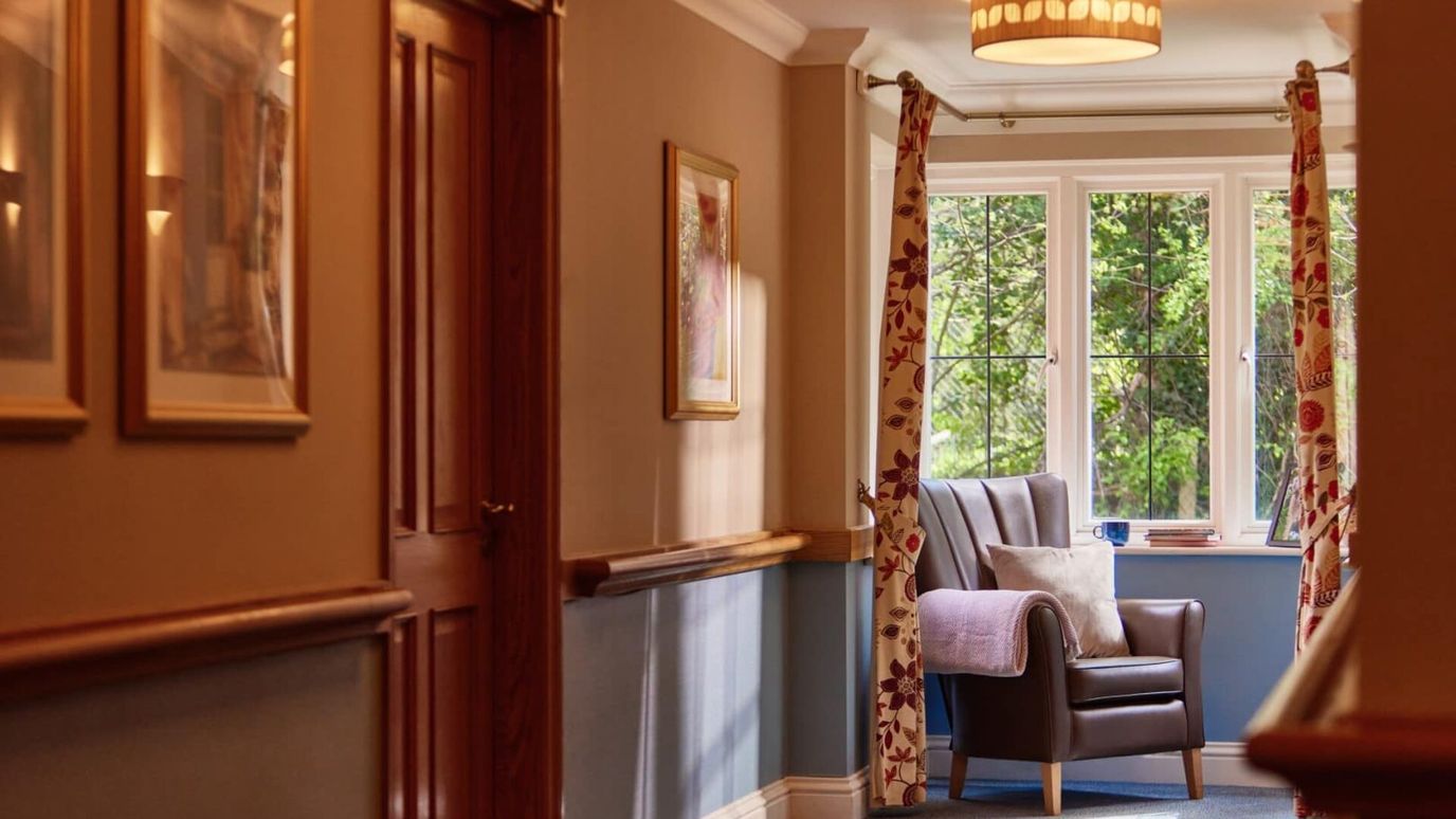 Interior hallway with a chair and large window