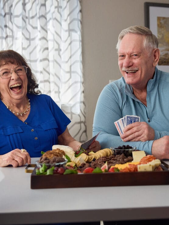 Residents enjoying a meal and playing cards