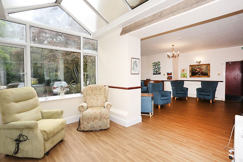 Lounge area with armchairs and a view of the garden