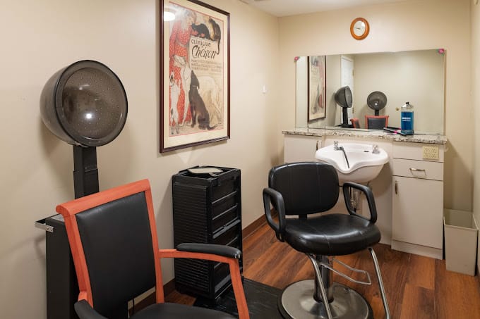 Hair salon with styling chairs and a hair dryer.