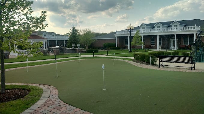 View of the garden area with putting green and benches at The Cottages of New Lenox.