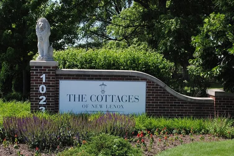 Sign of The Cottages of New Lenox with lion statue