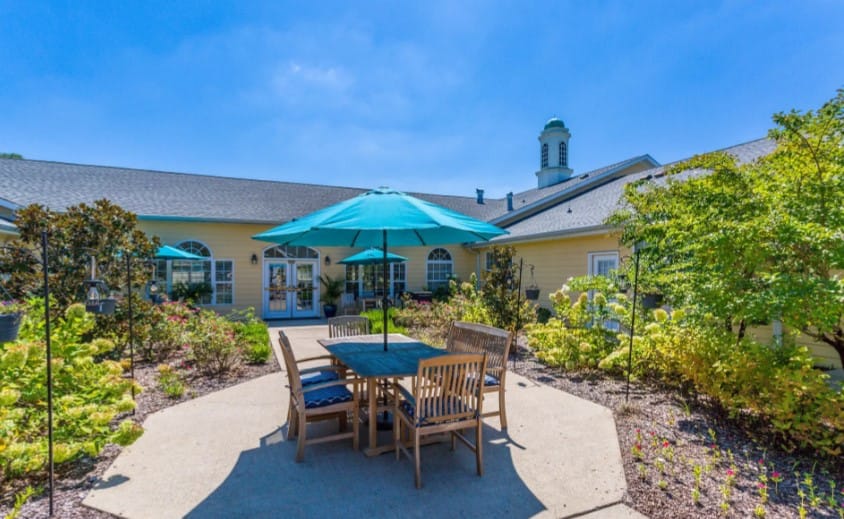 Outdoor patio with table and chairs under an umbrella