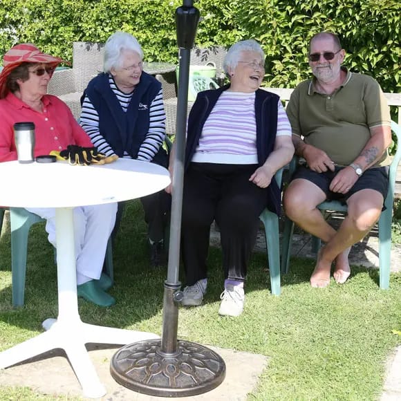 Residents enjoying time together outdoors in a garden setting