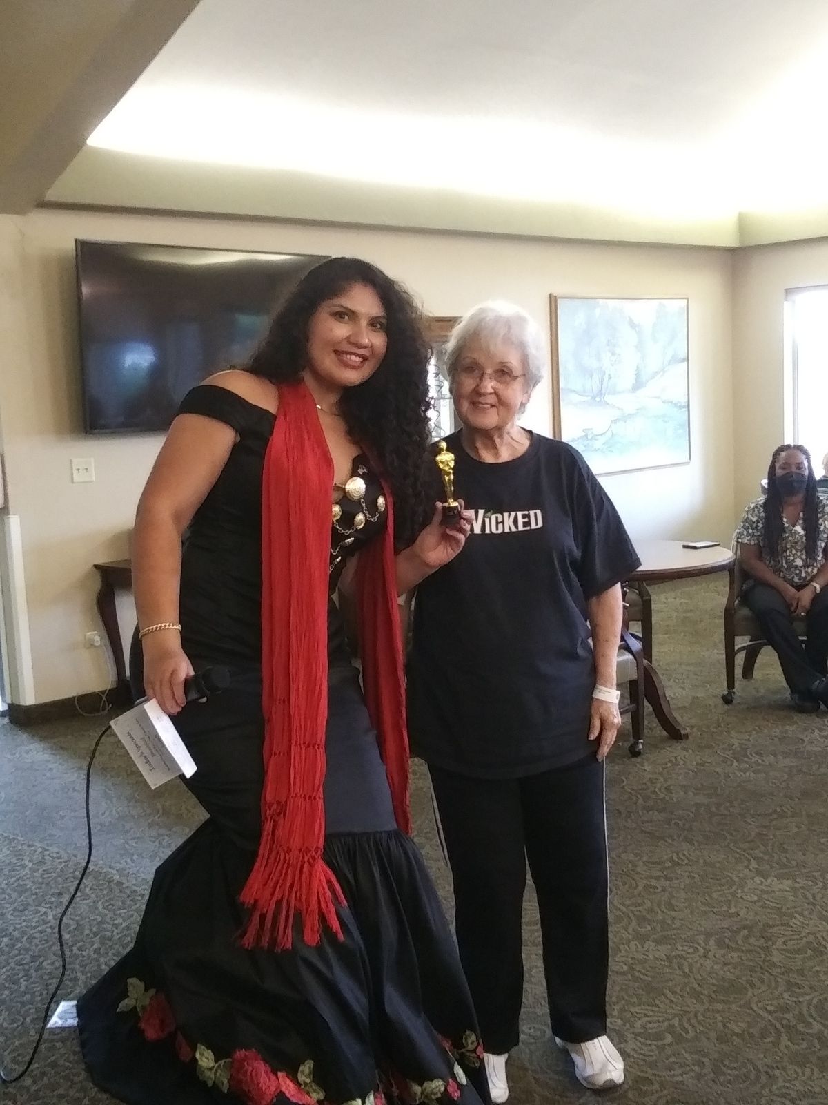 A resident and staff member at a celebration event