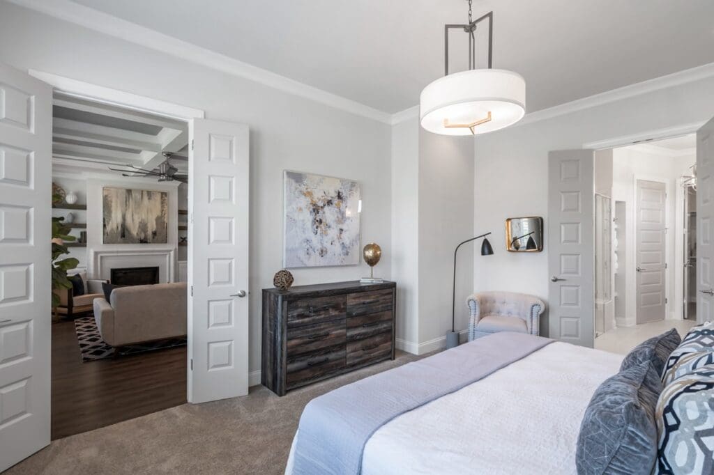 Brightly lit bedroom with modern decor and open doors
