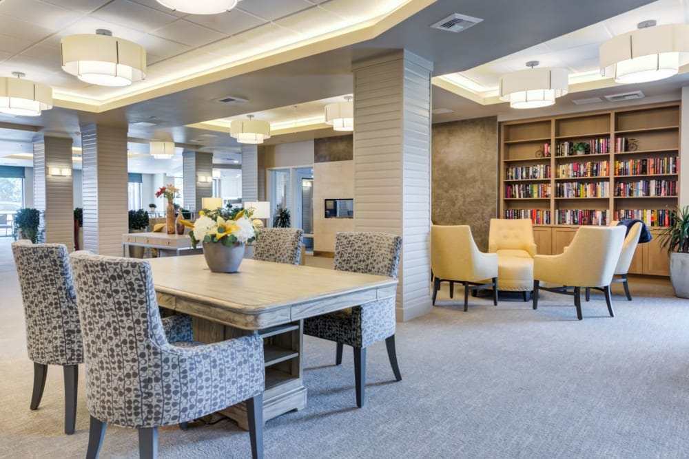 Bright and welcoming common area with seating and bookshelf