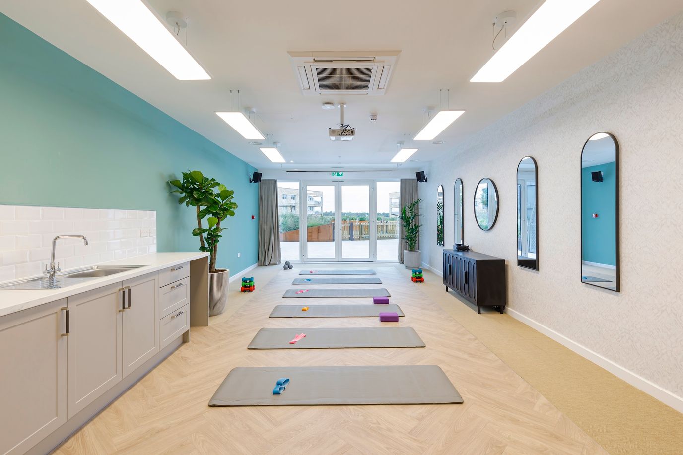 Bright interior fitness/activity room with exercise mats