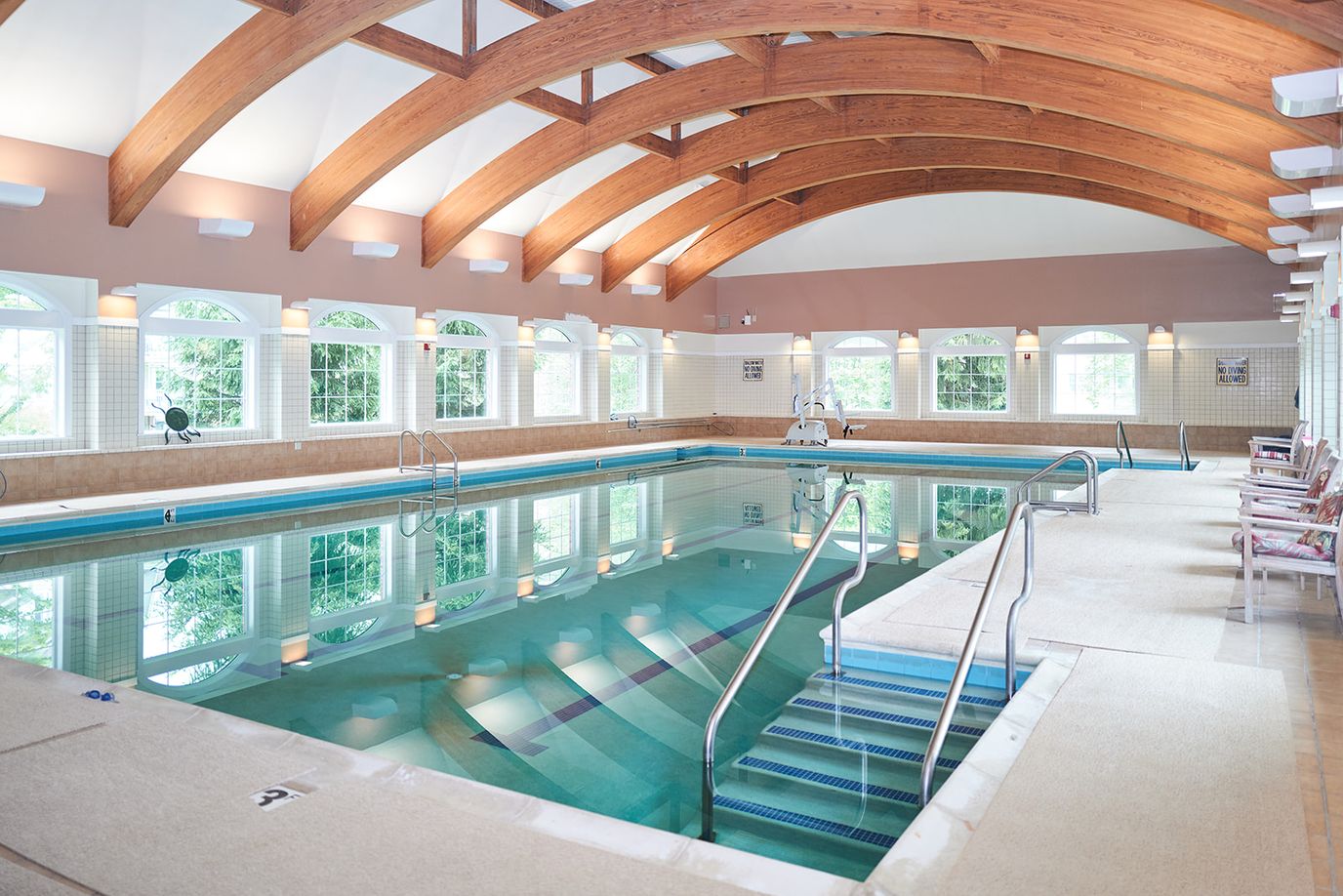 Indoor pool area with wooden beams and natural light
