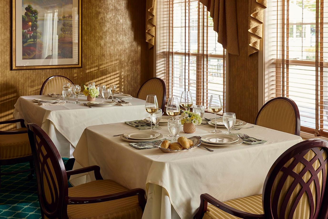Elegant dining room setup with tables and flowers