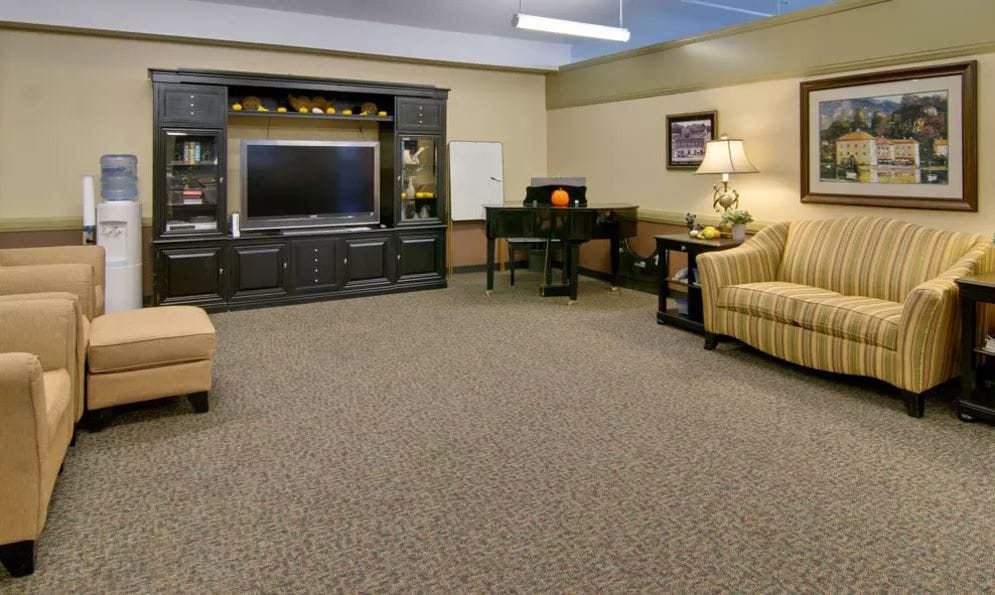 Cozy common area with seating, television, and a piano.