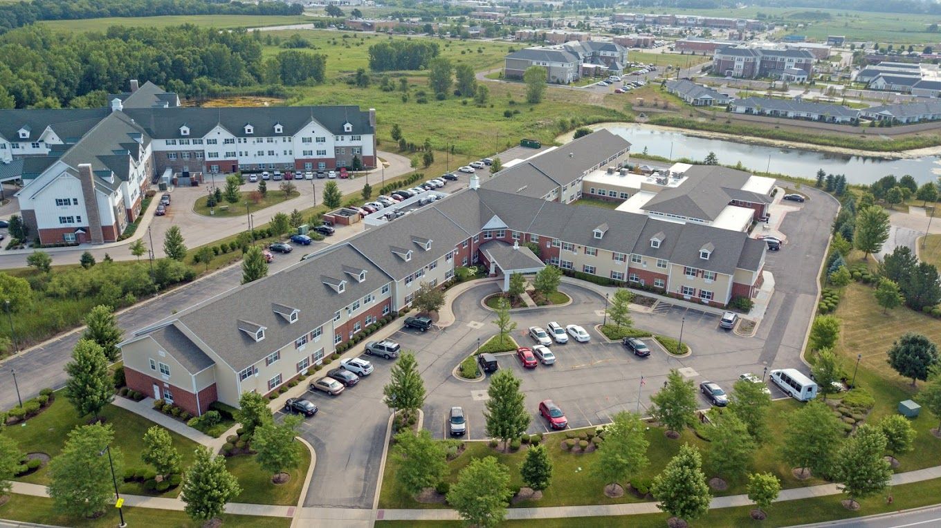 Aerial view of Heritage Woods of Huntley surrounded by green spaces and parking.