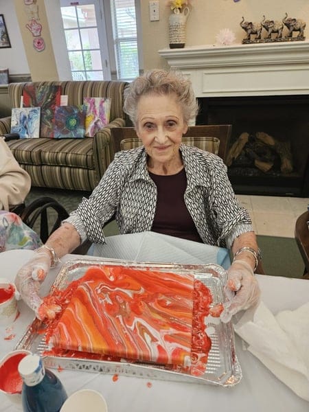 Resident engaging in an art activity indoors
