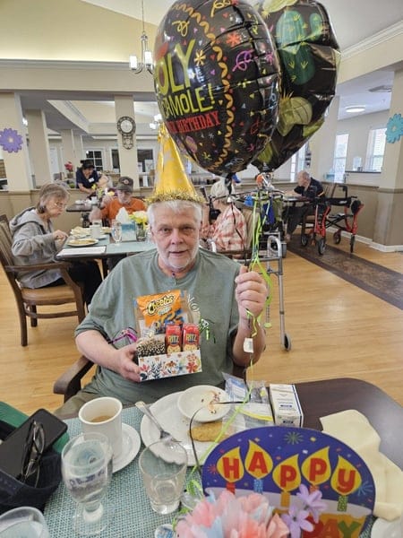 Resident celebrating birthday with snacks and balloons