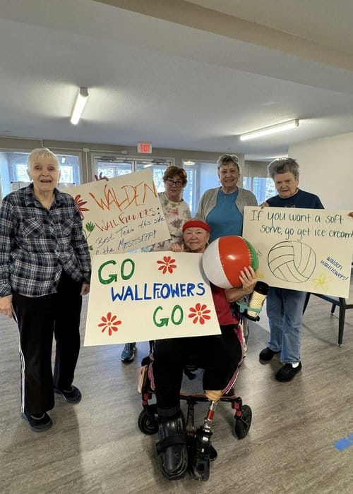 Residents cheering with signs during an activity