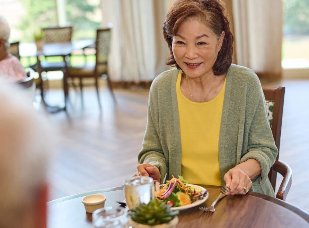 Resident enjoying a meal in the dining room