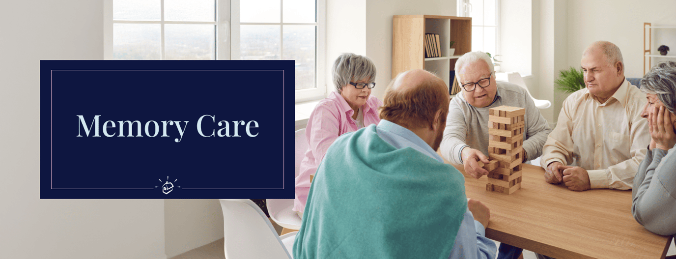Residents engaging in a memory care activity at a table.
