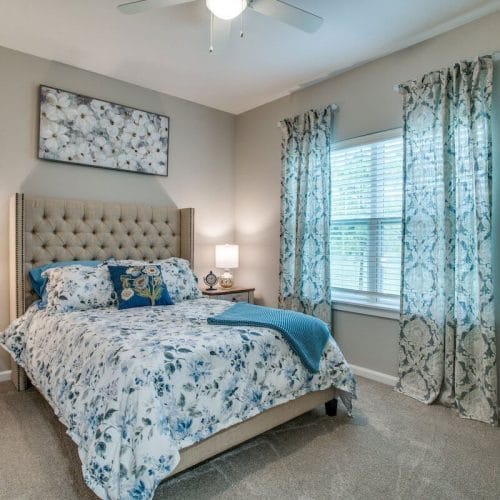 Cozy bedroom with floral bedding and window