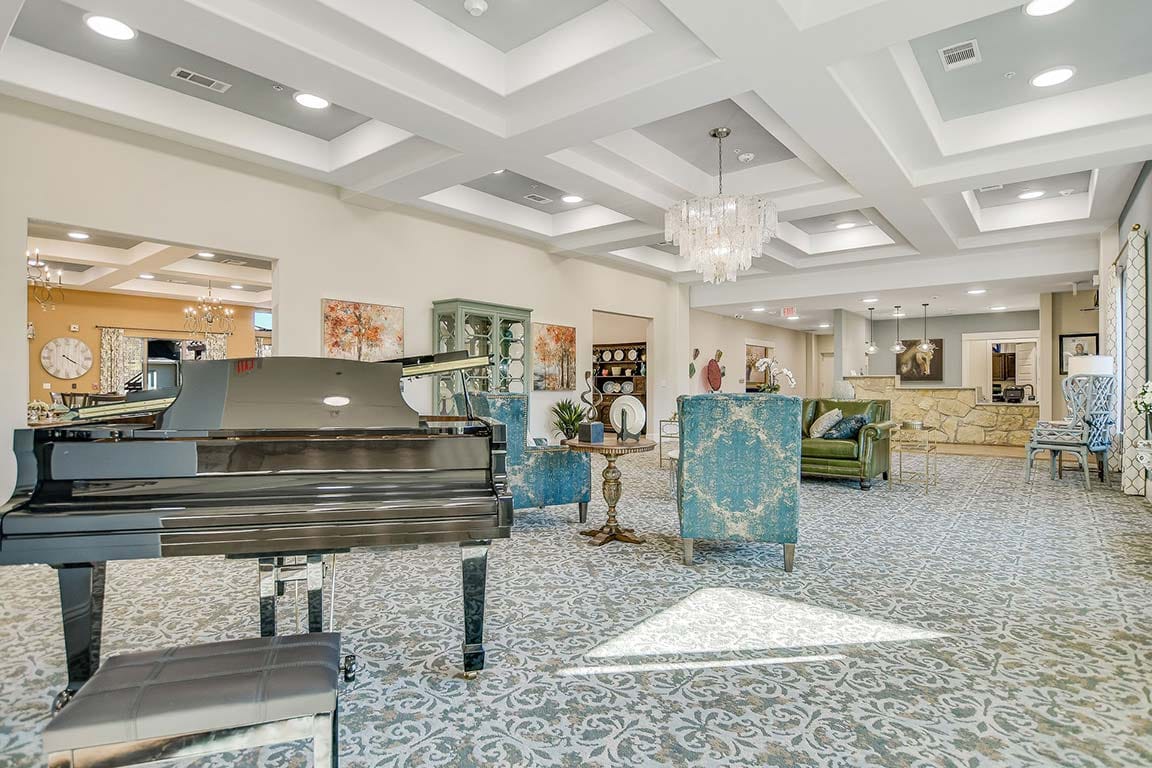 Bright, spacious interior of a common area with a piano