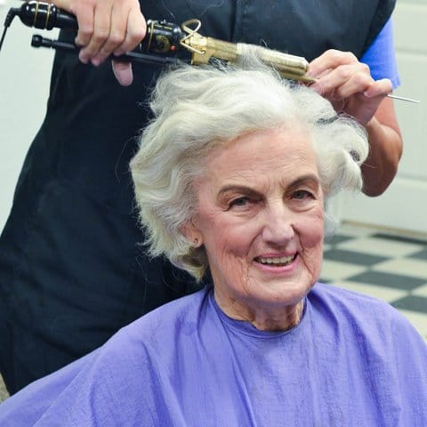 Senior resident receiving a hairstyle in a salon