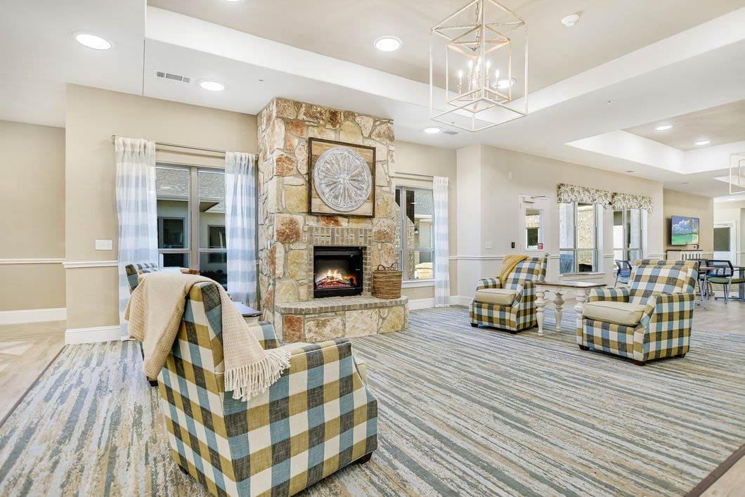 Bright common area with cozy seating and fireplace