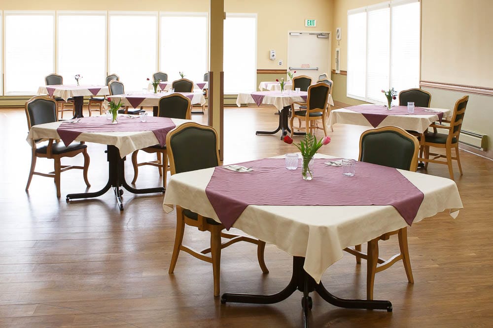 Dining room setup with tables and flowers