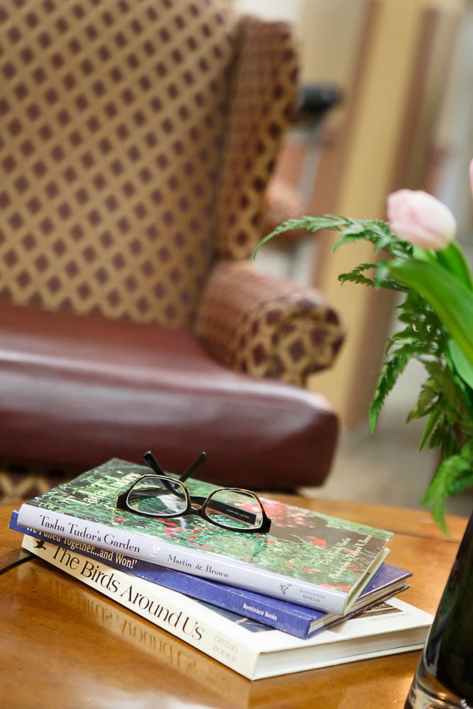 Cozy common area with books and reading glasses