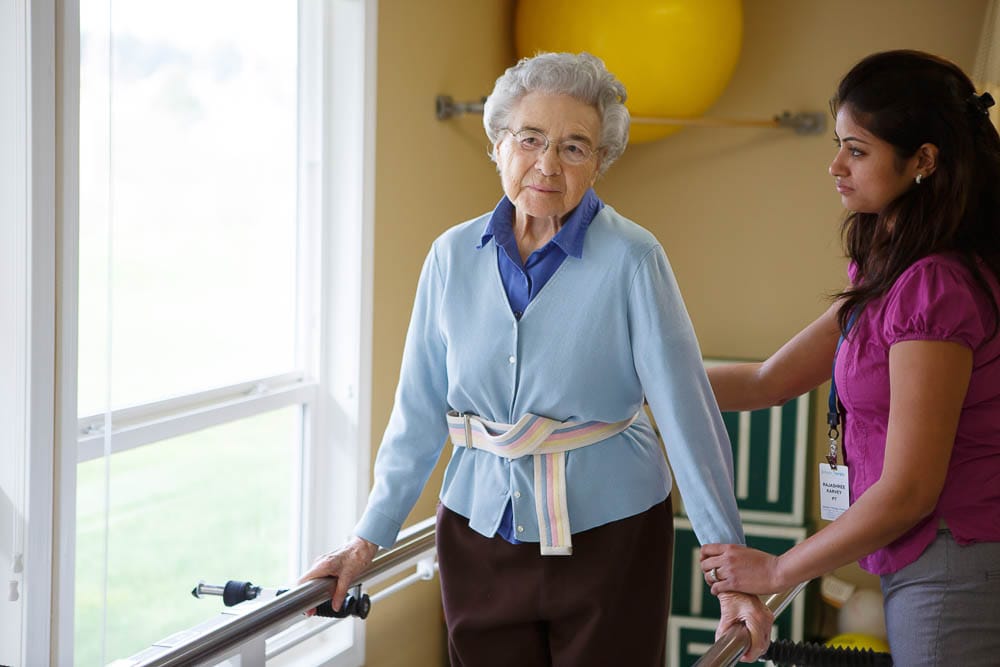 A staff member assisting a resident during therapy