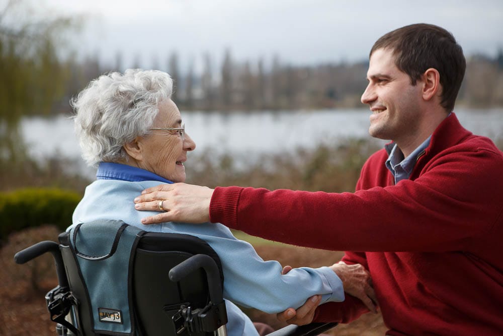 Caregiver interacting with a resident outdoors
