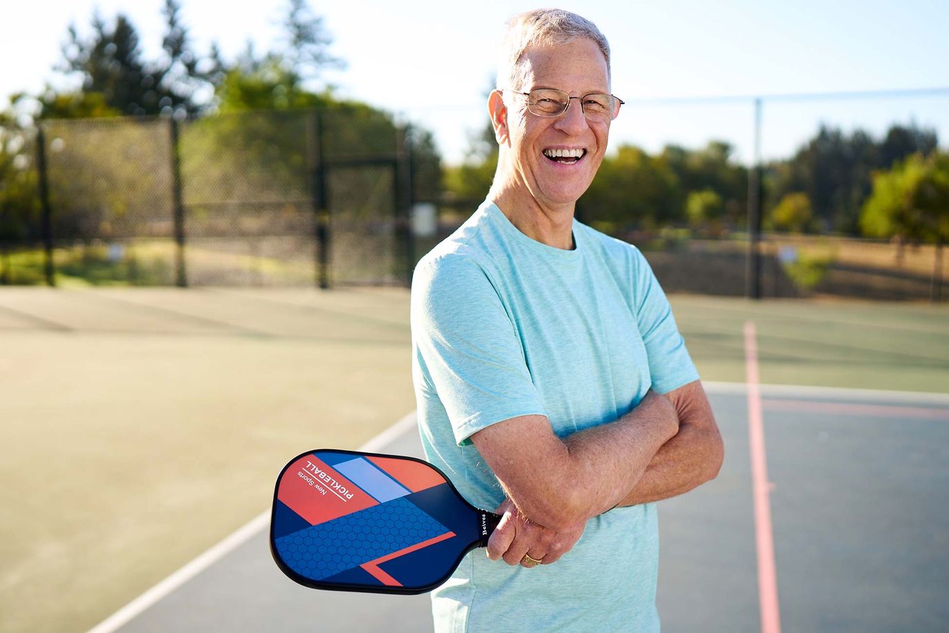 Senior resident enjoying pickleball outdoors