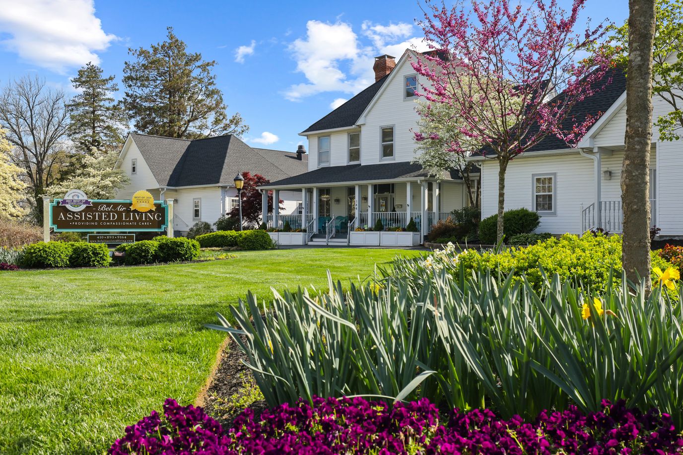 Exterior view of an assisted living facility with landscaped gardens