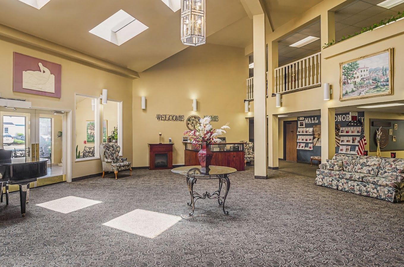 Bright and inviting lobby with a piano and floral arrangement