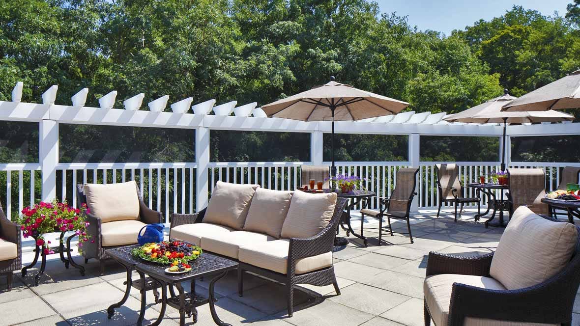 Patio with seating and umbrellas at The Cottage at Litchfield Hills