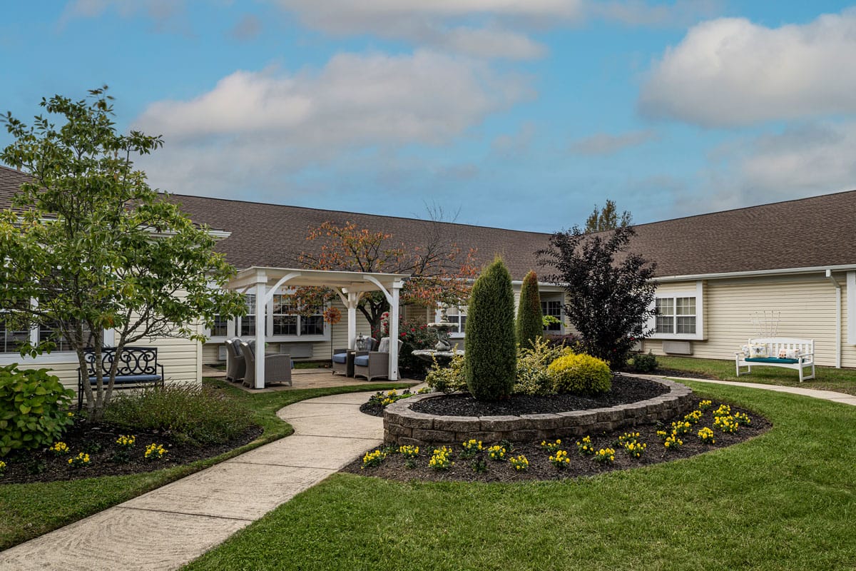 Peaceful courtyard with flower beds and seating area.