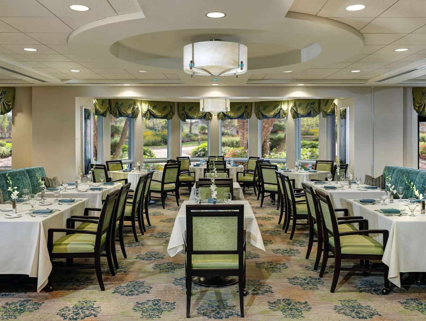 Elegant dining room setup with green decor and table settings
